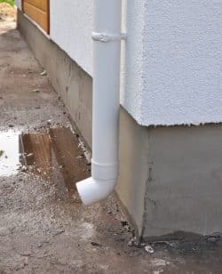 Downspout dumping water next to the foundation