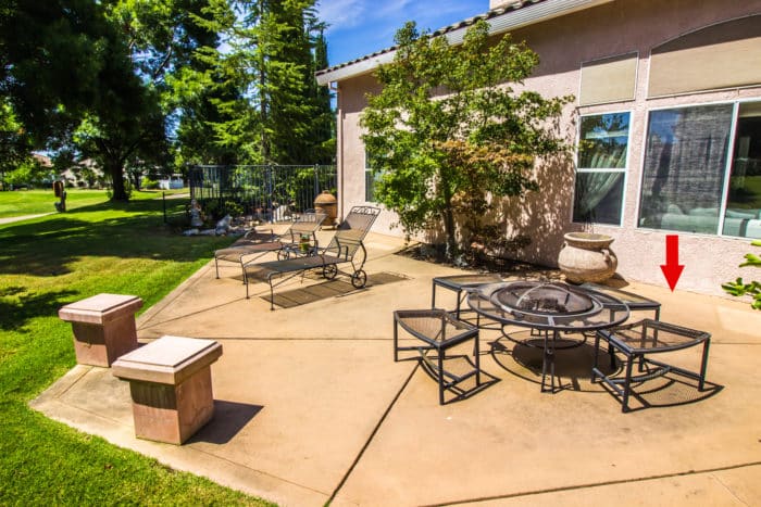 Concrete patio blocking weep screed