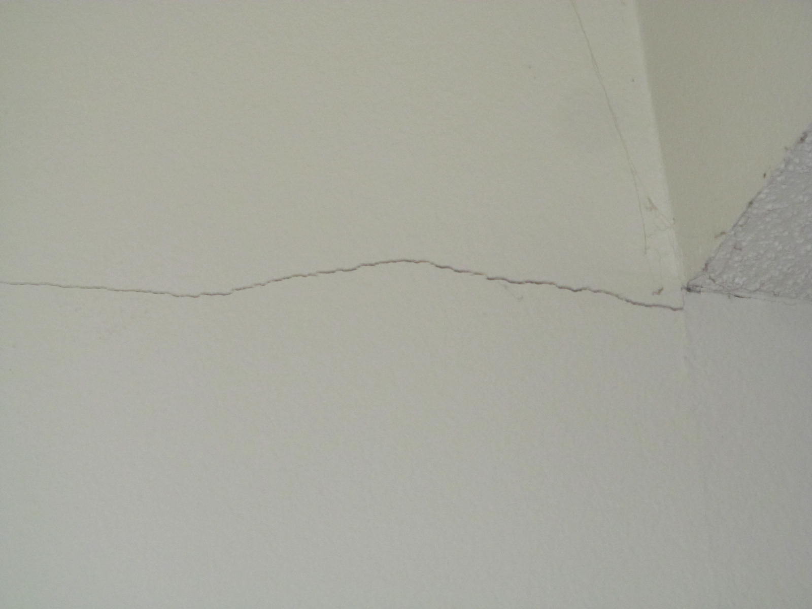 Hairline crack in drywall from joint