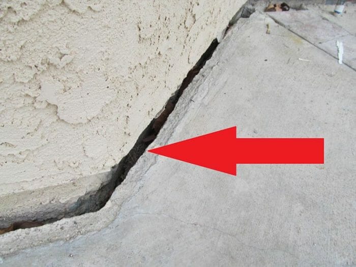 Slope creep patio slab pulled away from foundation