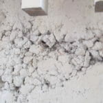 Rock pockets in concrete is where the rock, called aggregate, is exposed and is usually caused by failure to vibrate the concrete properly when pouring it.