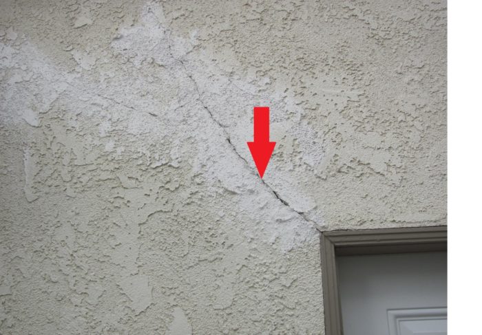 Stucco crack at door corner