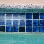 Tile Stained Around The Pool : calcium and mineral build-ups