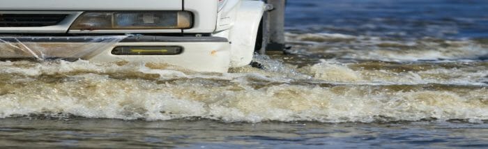 Truck running through rain storm