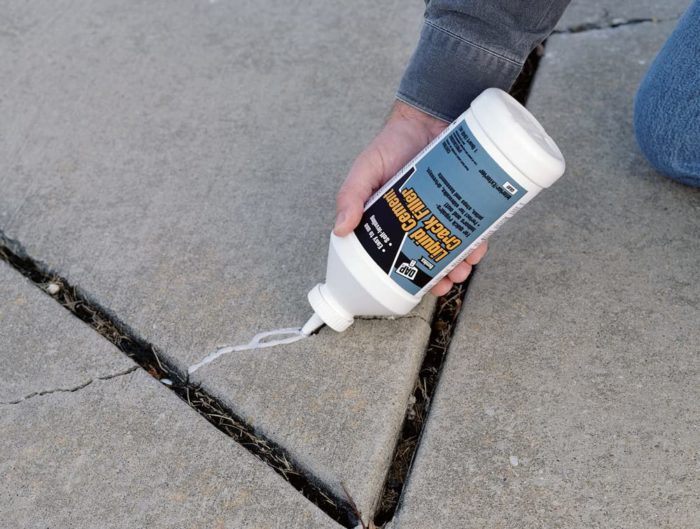 Concrete crack filler being squeezed into crack