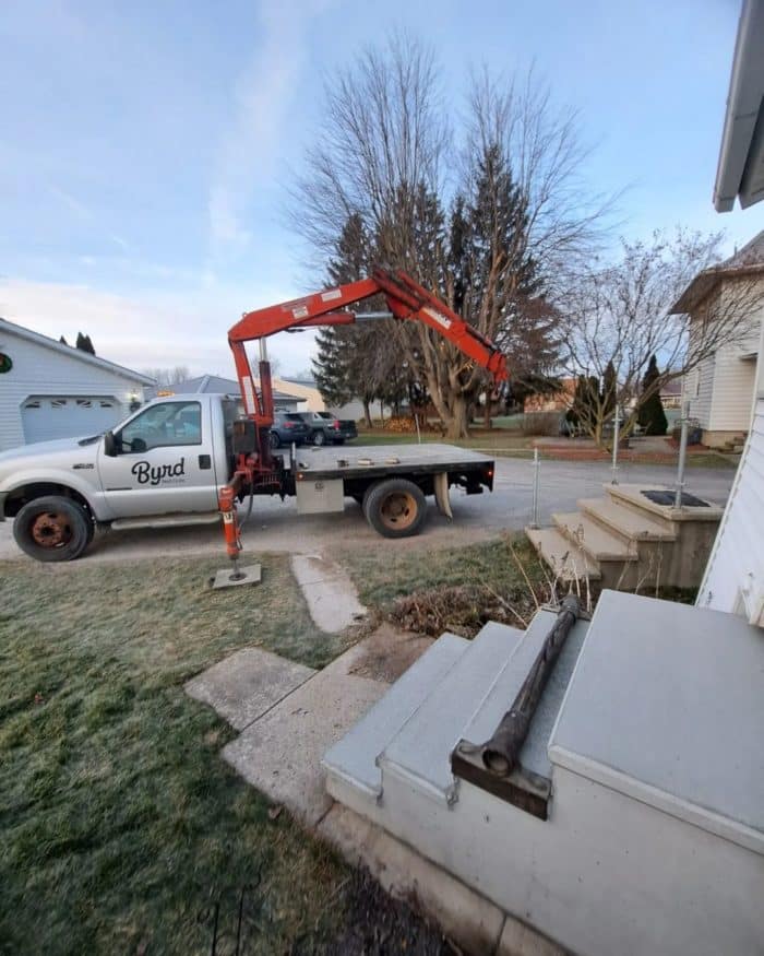 crane and precast steps in front yard