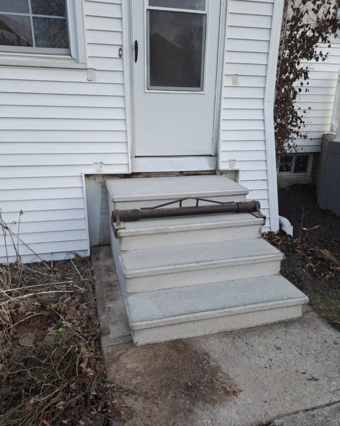 Precast concrete stairs installed up against rear door of home