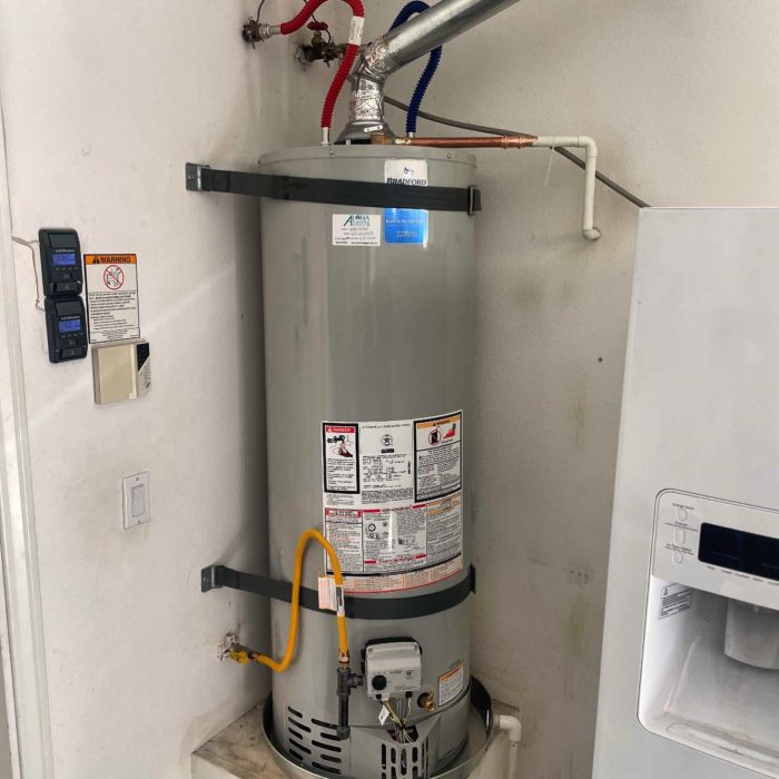 New gas water heater with seismic straps and water heater pan