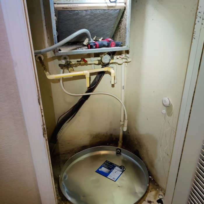 water heater removed showing mold